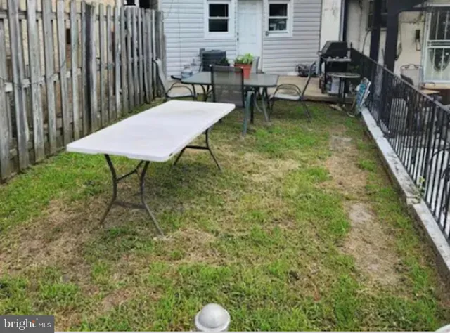 a view of a backyard with table and chairs