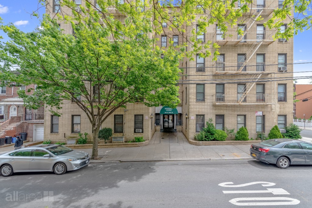 39-75 56th Street, Unit 2A Queens, NY 11377 - Photo 11 of 12 a car parked in front of a white house