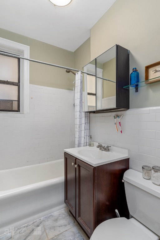 39-75 56th Street, Unit 2A Queens, NY 11377 - Photo 7 of 12 a bathroom with a toilet sink and mirror