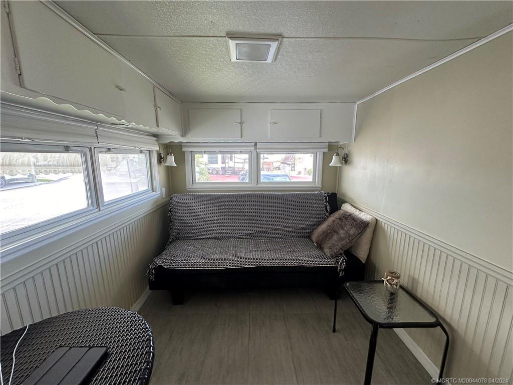 10725 South Ocean Drive, Unit 68 Jensen Beach, FL 34957 - Photo 15 of 27 a bedroom with furniture and window