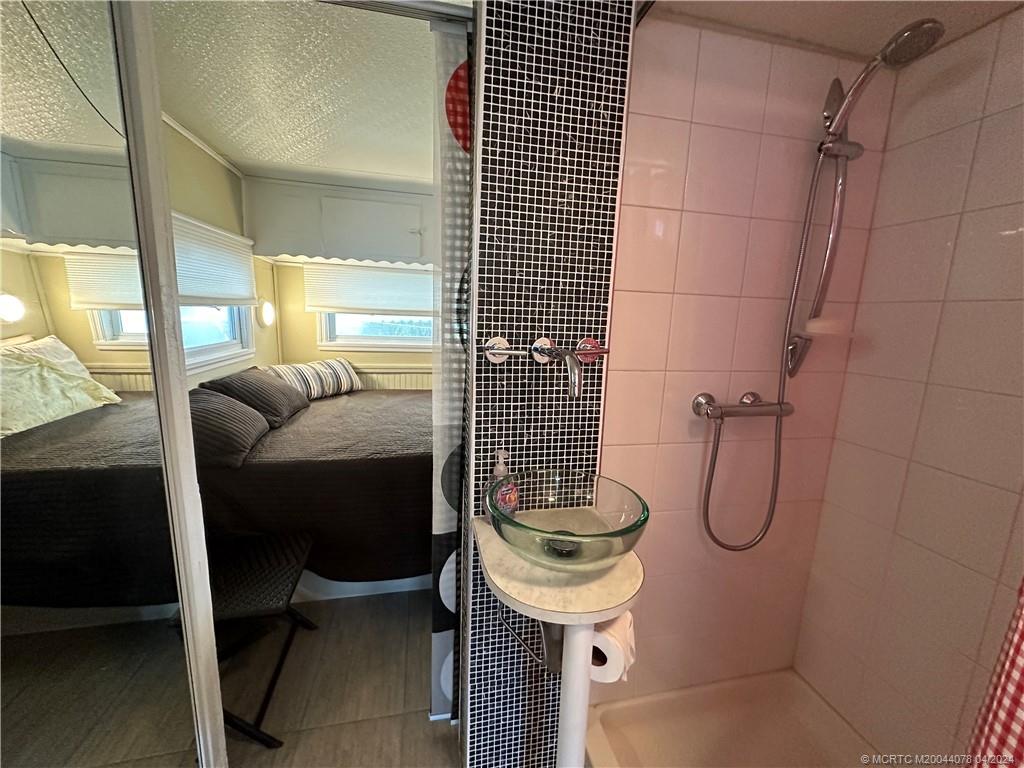 10725 South Ocean Drive, Unit 68 Jensen Beach, FL 34957 - Photo 17 of 27 a bathroom with a sink toilet and shower