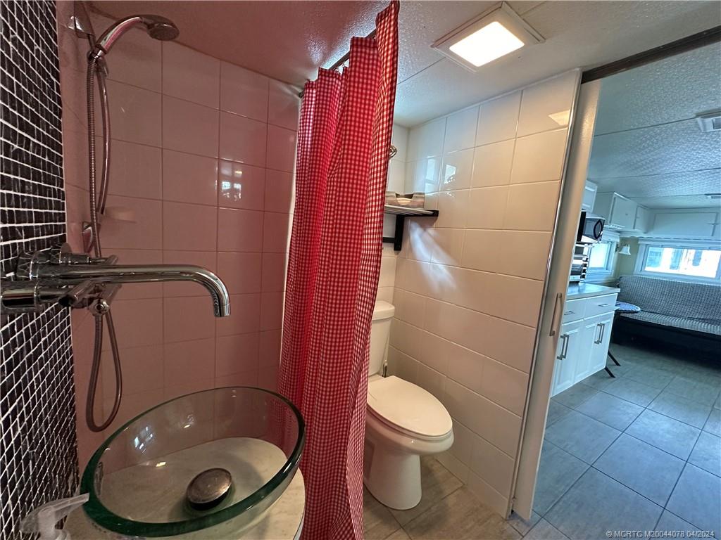 10725 South Ocean Drive, Unit 68 Jensen Beach, FL 34957 - Photo 18 of 27 a bathroom with a toilet and a sink