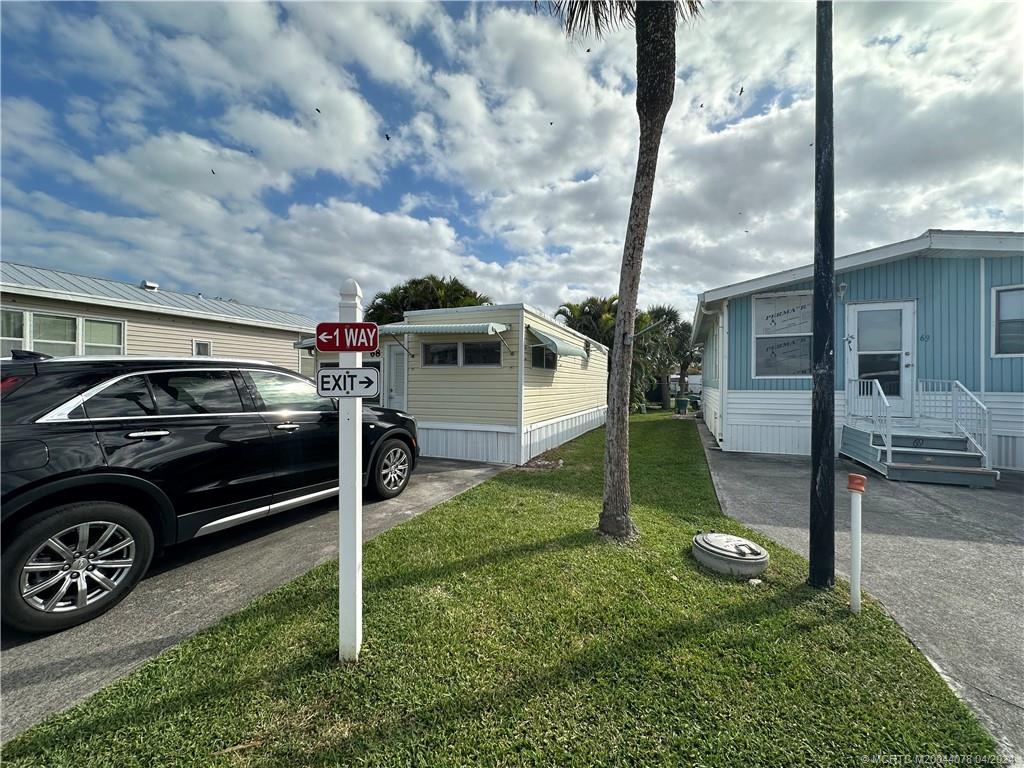 10725 South Ocean Drive, Unit 68 Jensen Beach, FL 34957 - Photo 5 of 27 a view of a car park in front of house