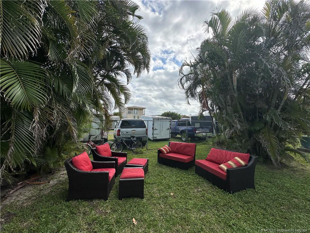 10725 South Ocean Drive, Unit 68 Jensen Beach, FL 34957 - Photo 6 of 27 a backyard of a house with fire pit and outdoor seating