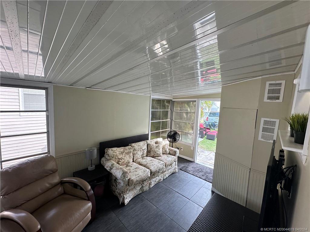 10725 South Ocean Drive, Unit 68 Jensen Beach, FL 34957 - Photo 10 of 27 a living room with furniture and a flat screen tv