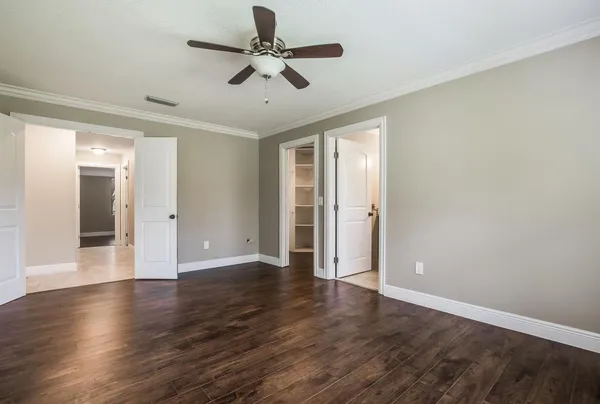 a view of an empty room with wooden floor