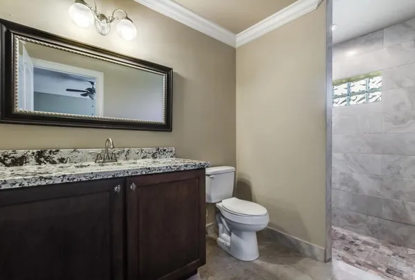 a bathroom with a toilet sink and mirror