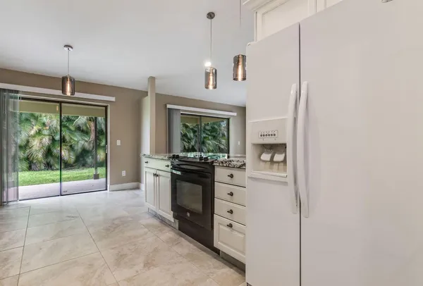 a kitchen with stainless steel appliances granite countertop a stove and a refrigerator