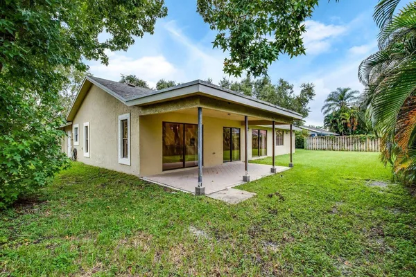 a view of an house with backyard space and garden