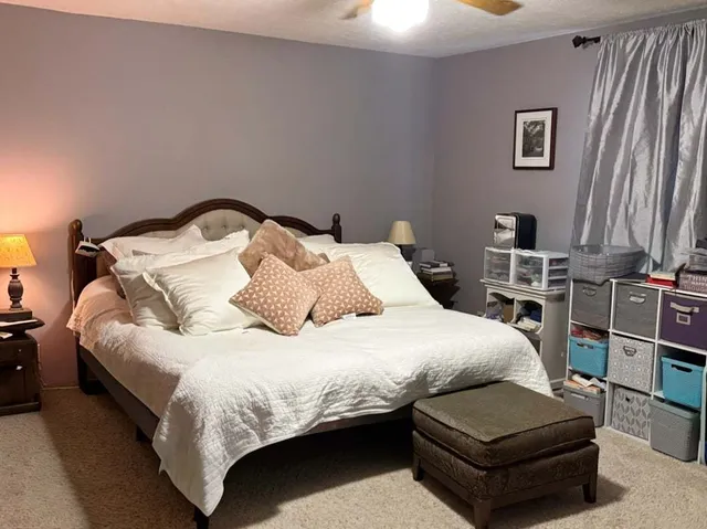 a bedroom with a bed couch and a window