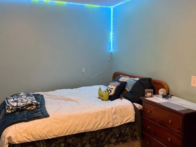 a bedroom with a bed and a window