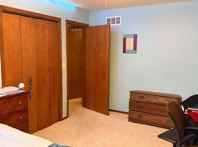 a bedroom with a bed and a furniture