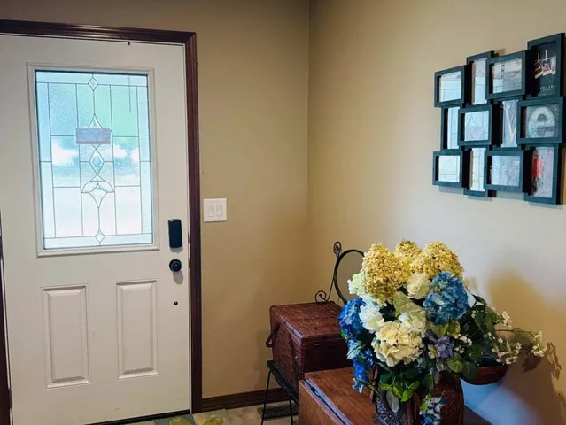 a vase of flowers sitting on a bookshelf