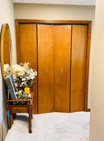 a bedroom with a bed table and a window