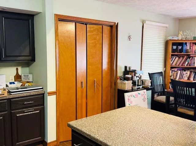 a kitchen with a stove a refrigerator and a dining table