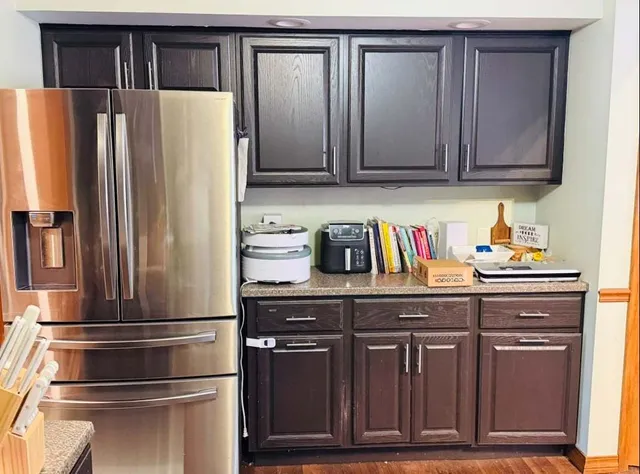 a kitchen with stainless steel appliances wooden cabinets and a refrigerator