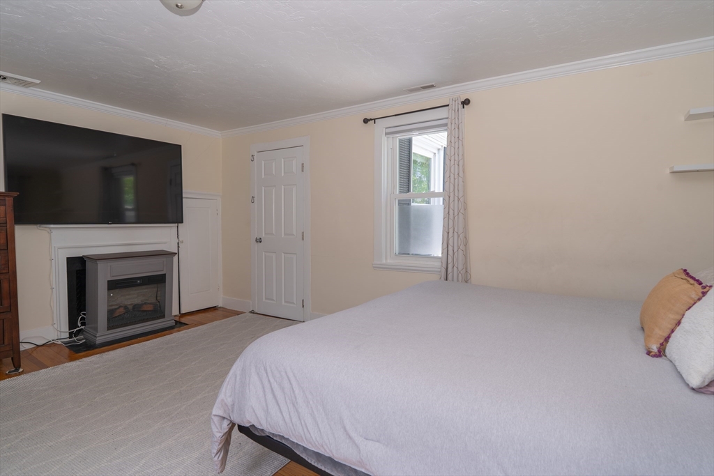 35 Neponset Street Canton, MA 02021 - Photo 25 of 29 a bed room with a fireplace and television