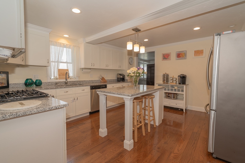 35 Neponset Street Canton, MA 02021 - Photo 6 of 29 a kitchen with granite countertop a sink appliances cabinets and wooden floor