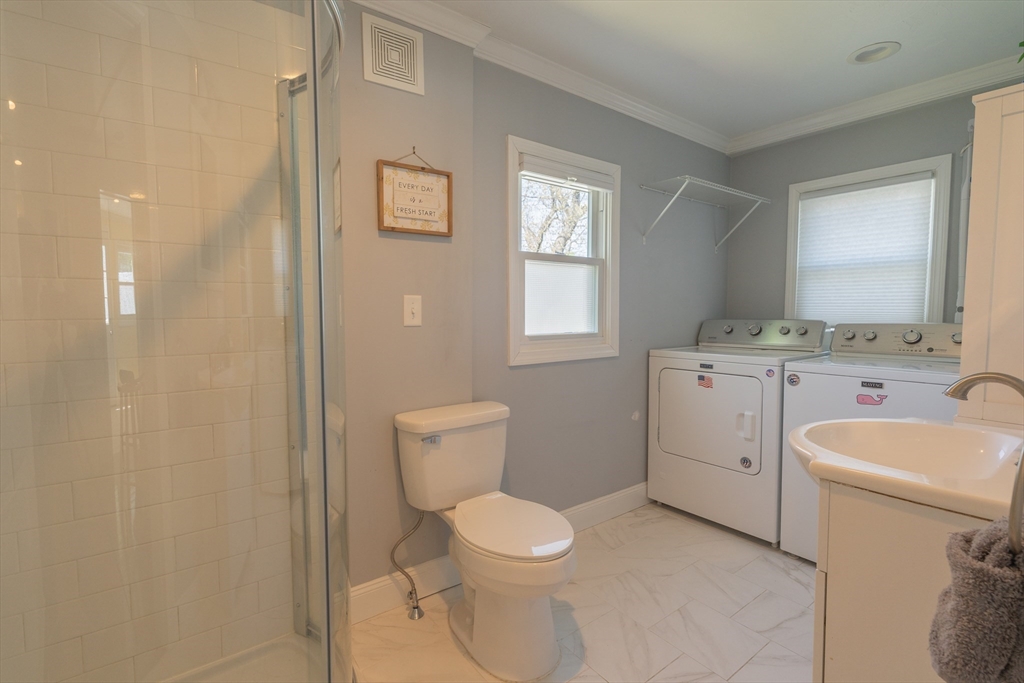 35 Neponset Street Canton, MA 02021 - Photo 10 of 29 a bathroom with a toilet a sink and a mirror