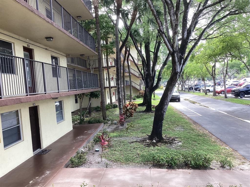 3161 Northwest 47th Terrace, Unit 317 Lauderdale Lakes, FL 33319 - Photo 11 of 20 a backyard of a house with lots of green space