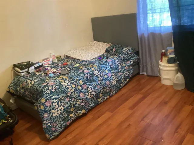 a bed sitting in a bedroom next to a window