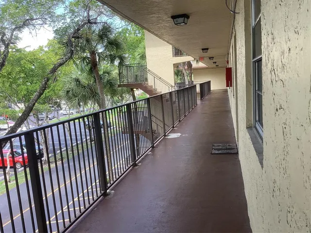 a view of a balcony with wooden floor