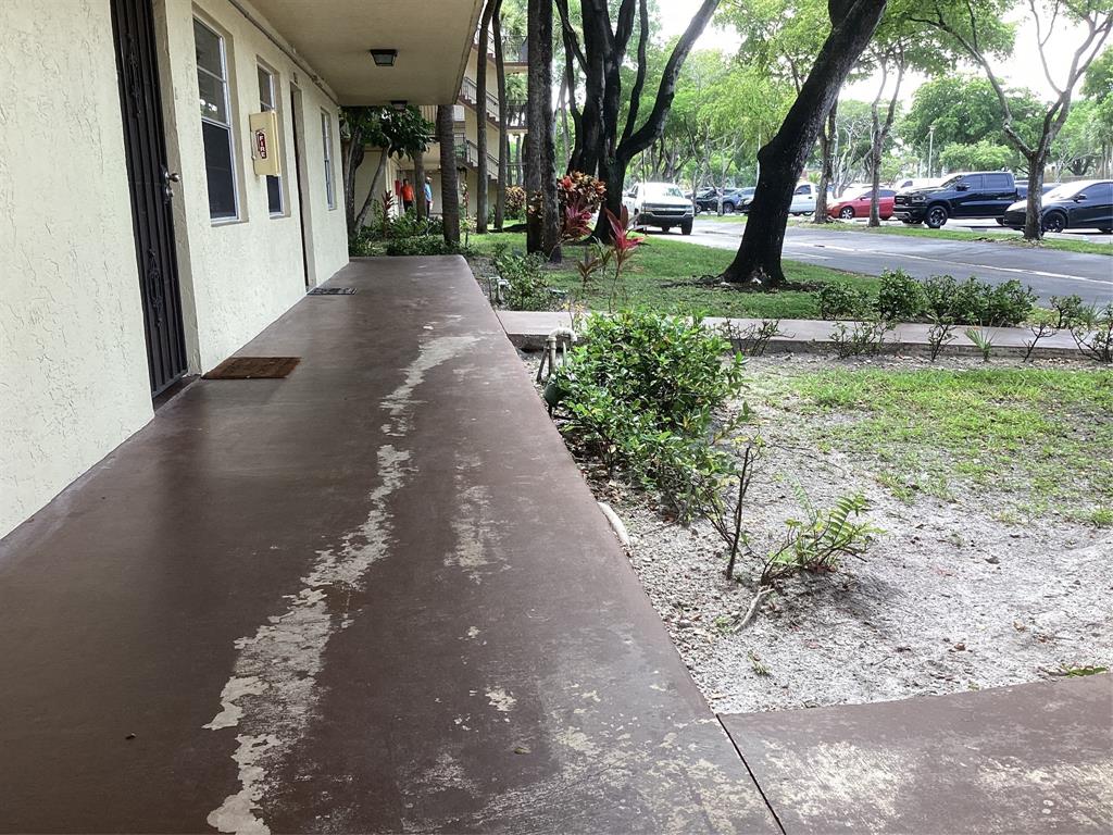 3161 Northwest 47th Terrace, Unit 317 Lauderdale Lakes, FL 33319 - Photo 19 of 20 a view of a pathway with a yard