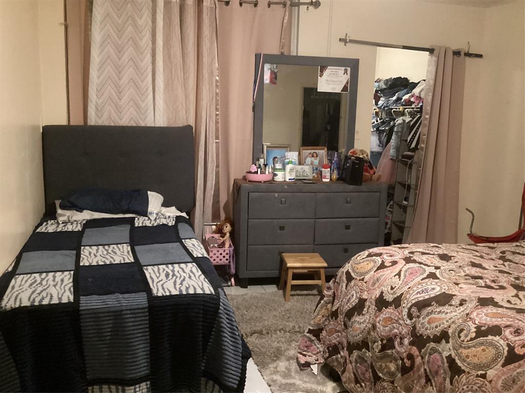 3161 Northwest 47th Terrace, Unit 317 Lauderdale Lakes, FL 33319 - Photo 10 of 20 a bedroom with a bed and a mirror on the dresser