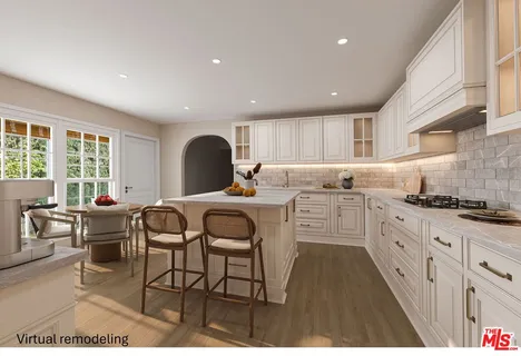 a kitchen with stainless steel appliances granite countertop a stove a sink a dining table and chairs