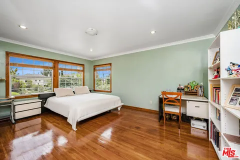 a living room with a bed furniture and a large window