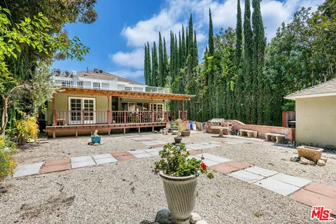 a view of a house with sitting area and potted plants