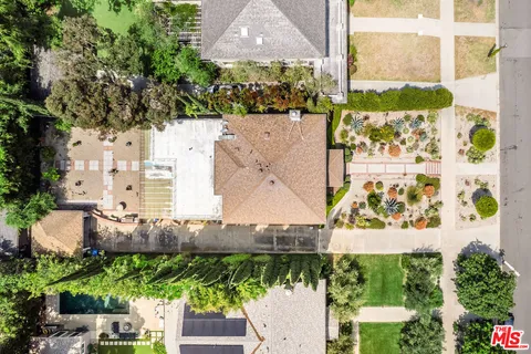 an aerial view of a house with a garden and a yard
