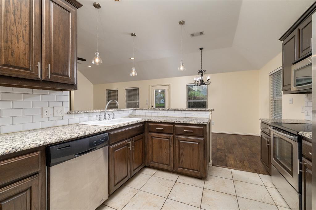 405 Kimbrough Road Azle, TX 76020 - Photo 15 of 39 a kitchen with a sink stove and cabinets