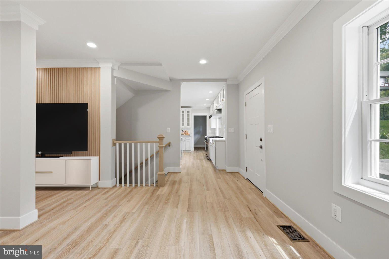 3517 Rodman Street Northwest Washington, DC 20008 - Photo 8 of 57 a view of a hallway with wooden floor and a flat screen tv