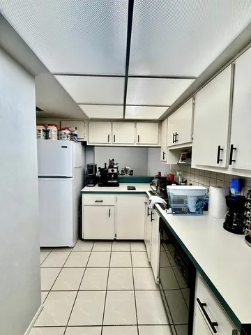 a kitchen with a white cabinets and white appliances