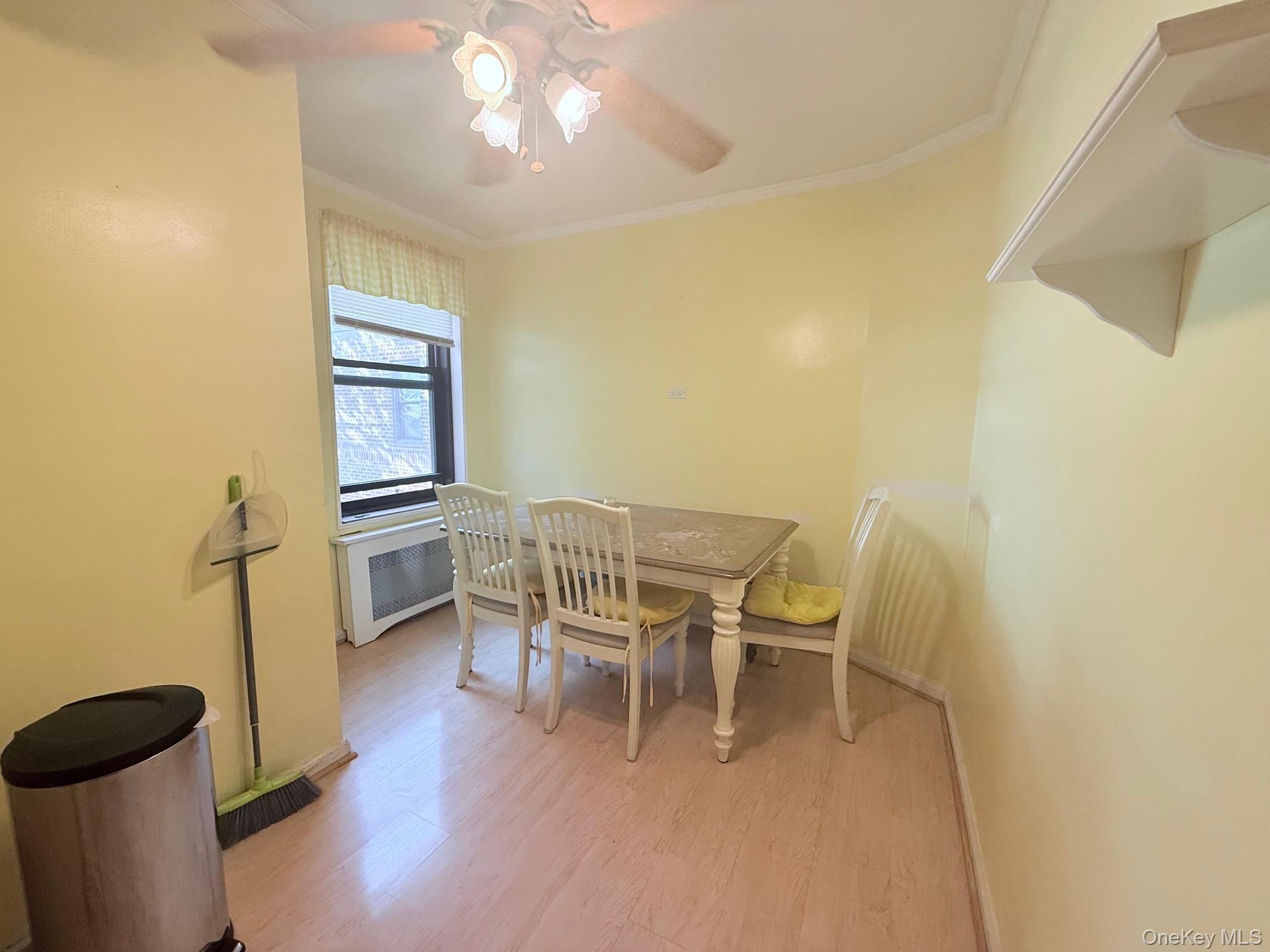 83-30 98th Street, Unit 6M Queens, NY 11421 - Photo 4 of 10 a dining room with furniture and wooden floor