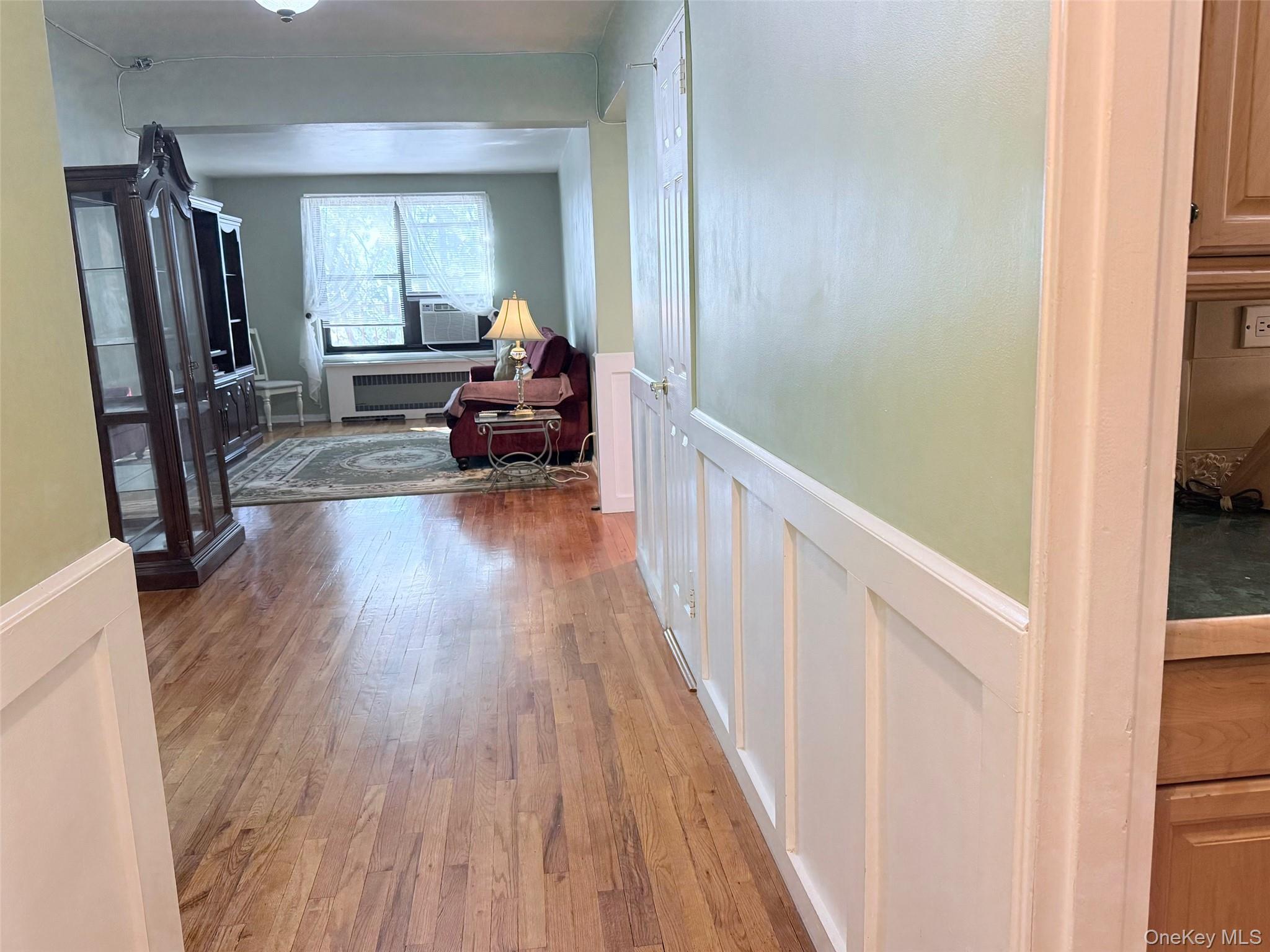 83-30 98th Street, Unit 6M Queens, NY 11421 - Photo 5 of 10 a view of a livingroom with furniture hardwood floor and hallway