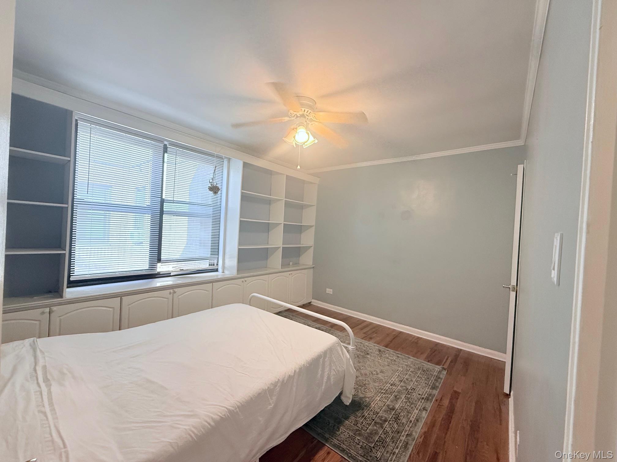 83-30 98th Street, Unit 6M Queens, NY 11421 - Photo 9 of 10 a bedroom with a bed and a window