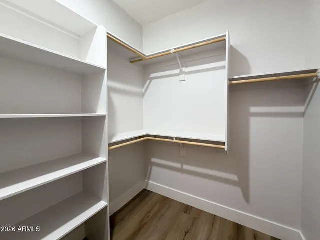 a view of walk in closet with empty racks