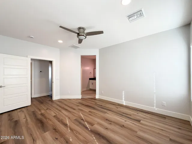 a view of empty room with wooden floor