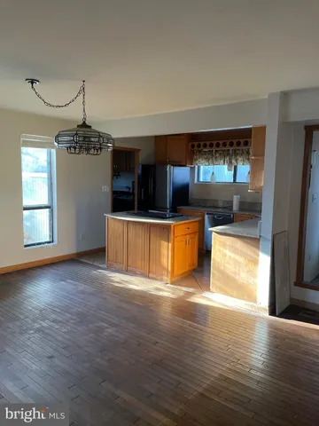 a view of a kitchen with a sink cabinets and wooden floor