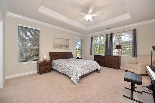 a bedroom with a bed and a chandelier