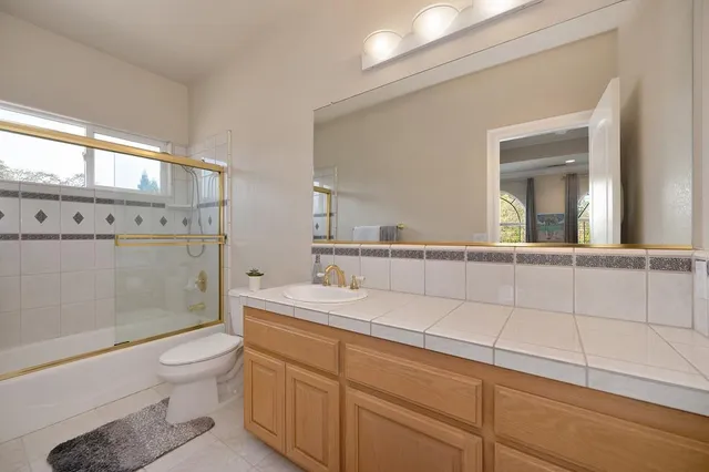 a bedroom with a bed dresser and a window