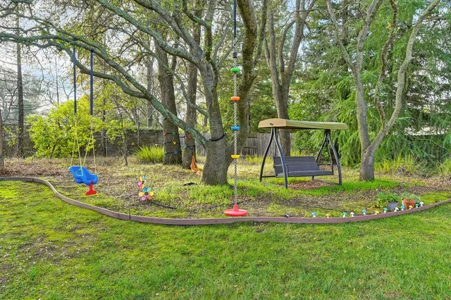 a view of a backyard with sitting area