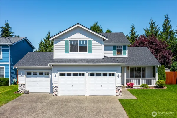 a front view of a house with a yard and garage