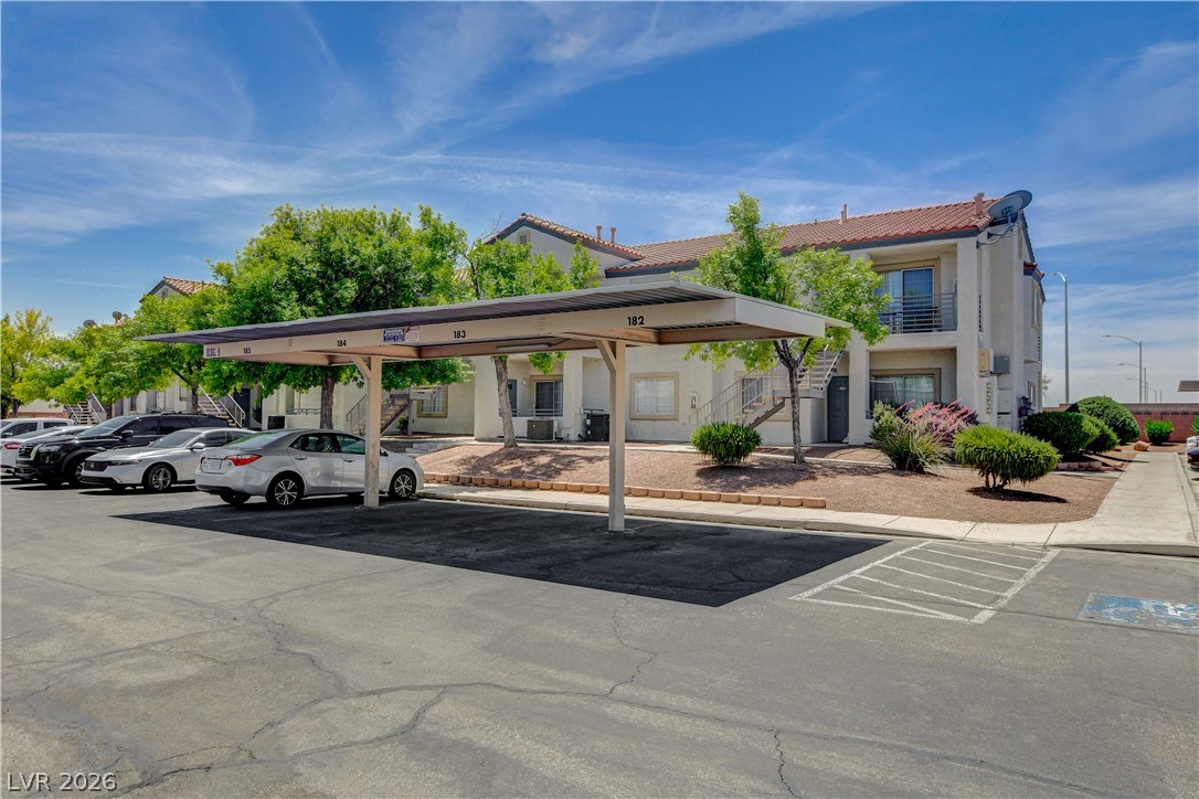3318 North Decatur Boulevard, Unit 1069 Las Vegas, NV 89130 - Photo 1 of 39 Secure covered parking complements this multi-level residential building, nestled amidst mature green landscaping.