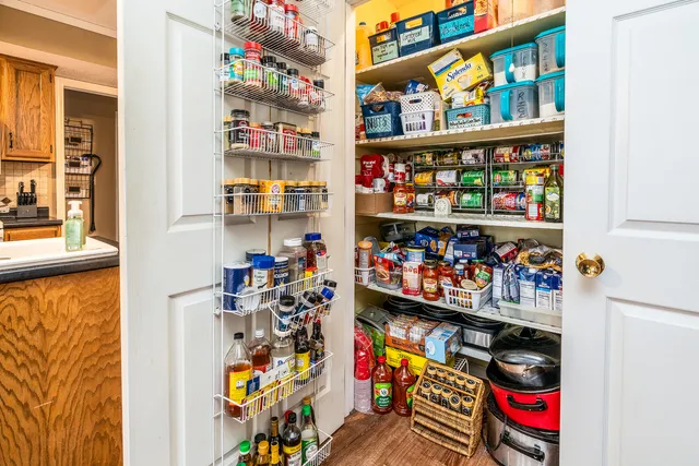 a kitchen with granite countertop a refrigerator and a stove top oven
