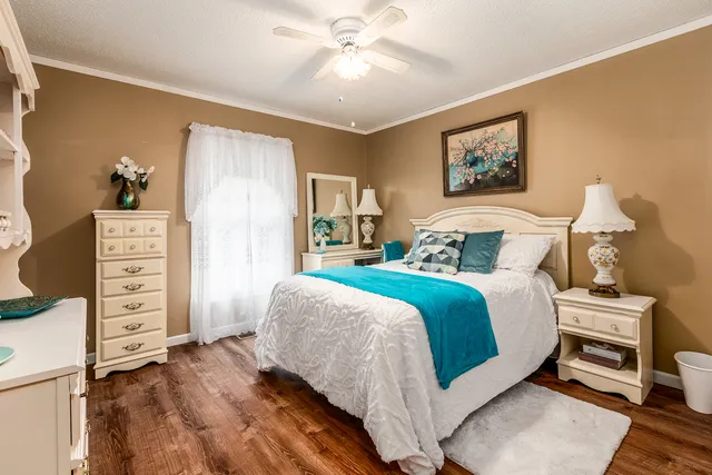 a bedroom with a bed and a chair