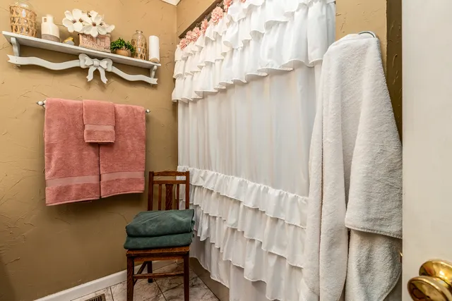 a bathroom with a sink a toilet and shower curtain