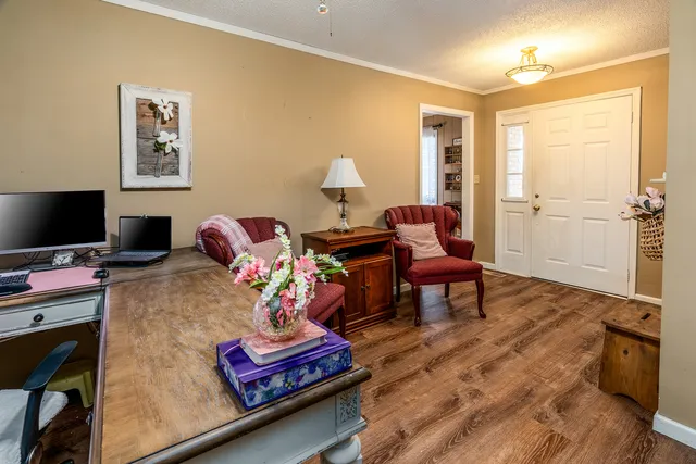 a living room with furniture and wooden floor